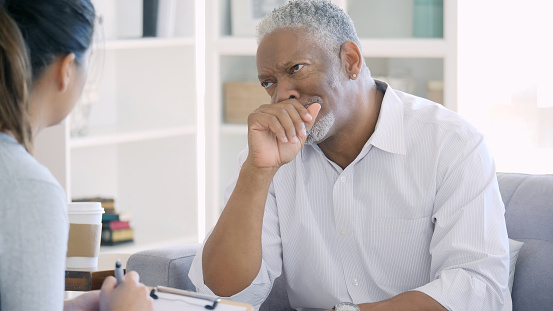 Upset senior man talks about issues with therapist