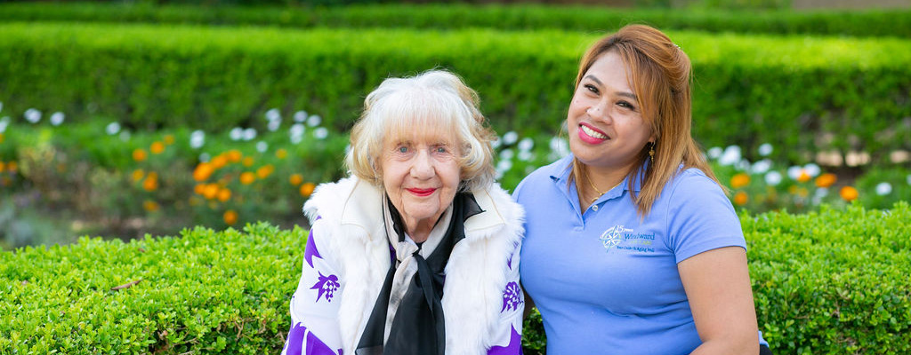 female staff member chatting with senior woman